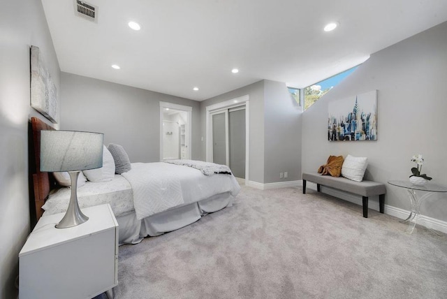 carpeted bedroom featuring connected bathroom and a closet