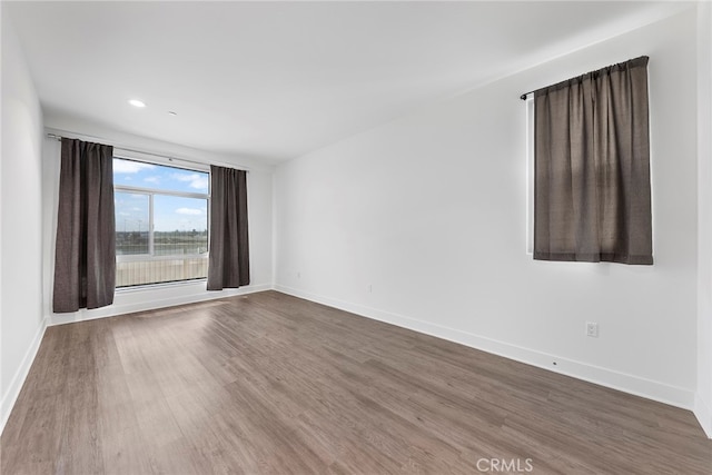 spare room featuring hardwood / wood-style flooring