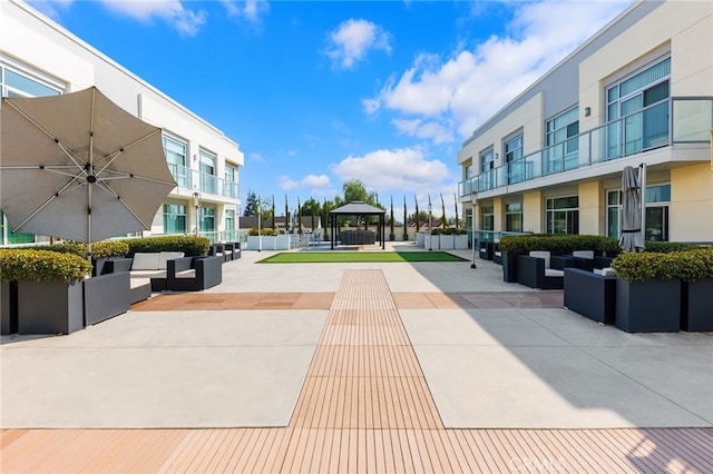 view of property's community with a patio, outdoor lounge area, and a gazebo