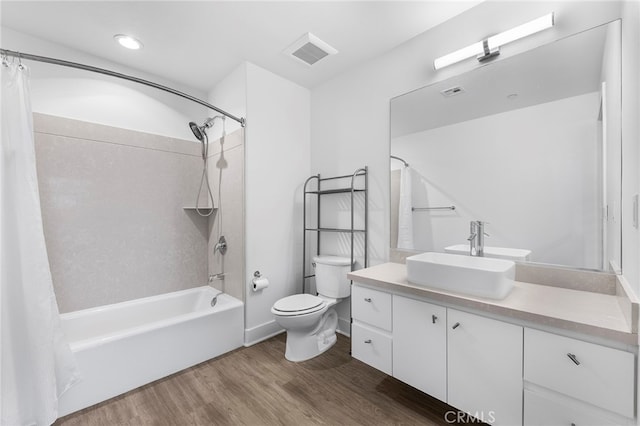 full bathroom with shower / tub combo, wood-type flooring, vanity, and toilet