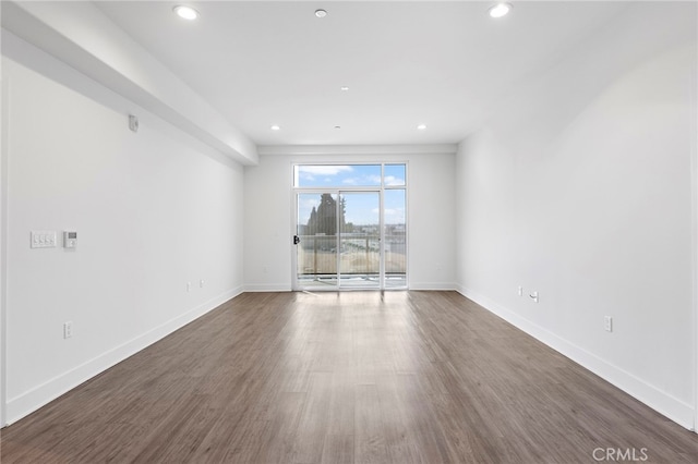 unfurnished room featuring dark wood-type flooring