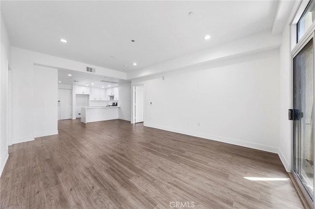 unfurnished living room with hardwood / wood-style flooring