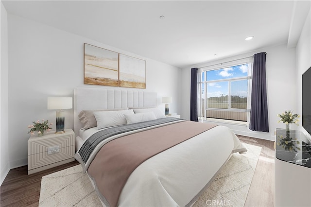 bedroom with hardwood / wood-style floors