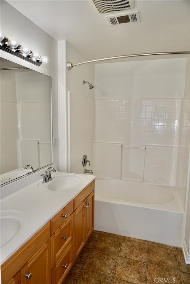 bathroom with tub / shower combination, vanity, and tile patterned floors