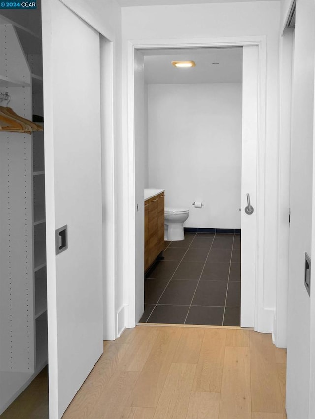 bathroom featuring vanity, hardwood / wood-style flooring, and toilet