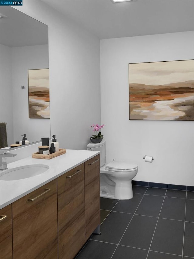 bathroom featuring tile patterned flooring, vanity, and toilet