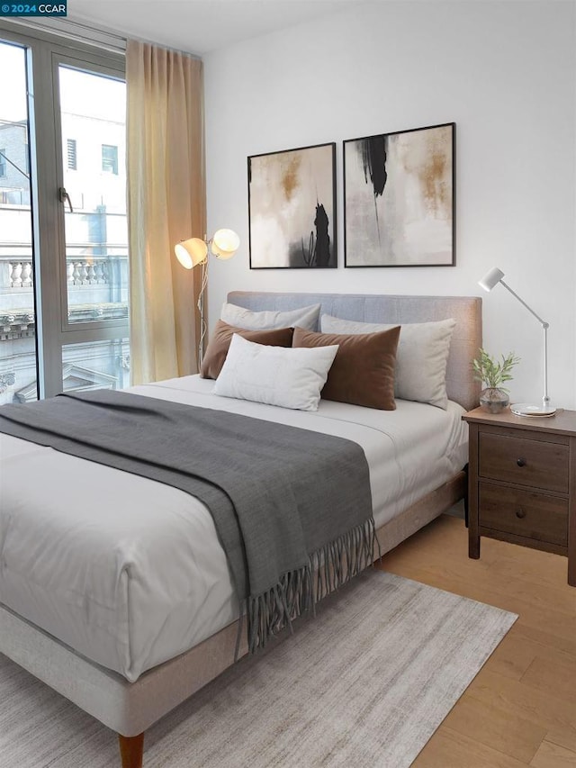 bedroom featuring access to outside and light hardwood / wood-style flooring