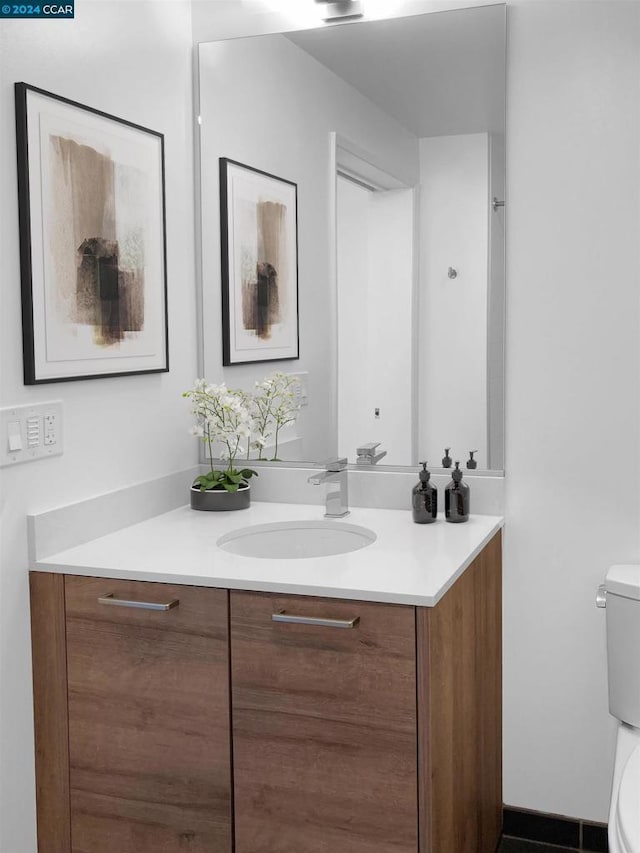 bathroom featuring vanity and toilet