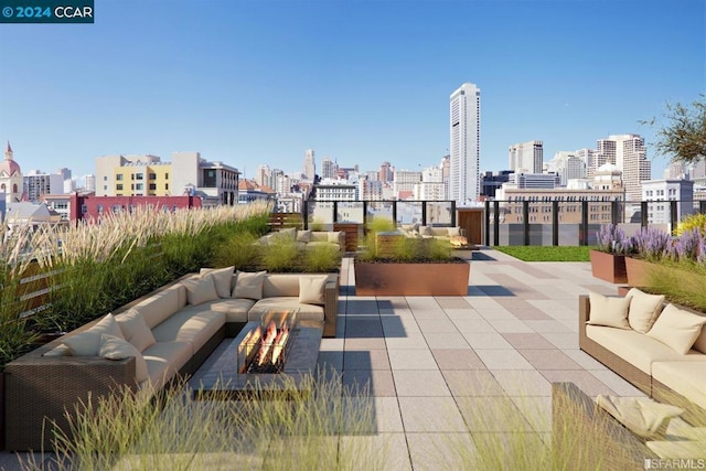 view of patio featuring an outdoor living space with a fire pit