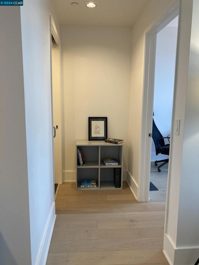 hall with light hardwood / wood-style floors