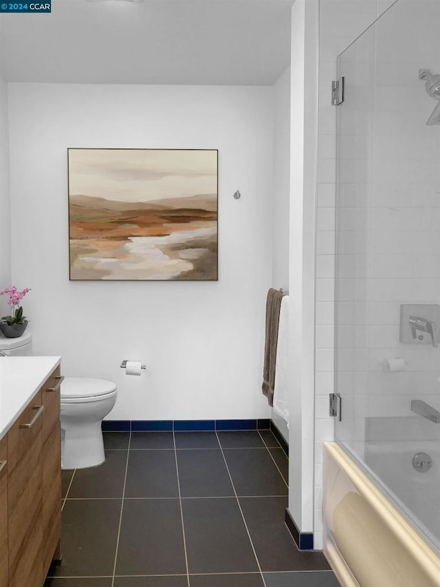 full bathroom featuring tile patterned flooring, vanity, toilet, and shower / bath combination with glass door