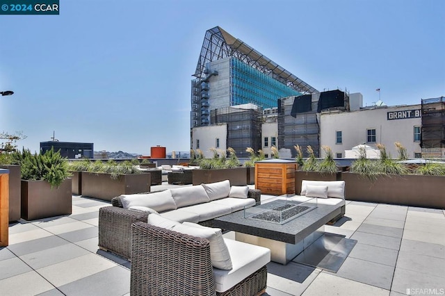 view of patio featuring an outdoor living space with a fire pit