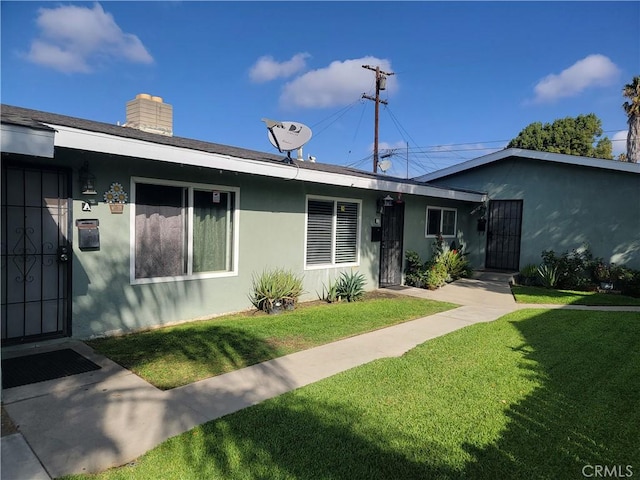 ranch-style house with a front lawn