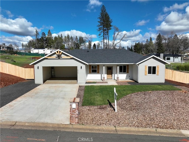 ranch-style home with fence, driveway, a porch, an attached garage, and a front lawn