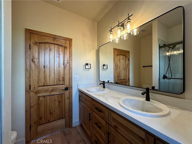 full bath with a shower stall, toilet, and a sink