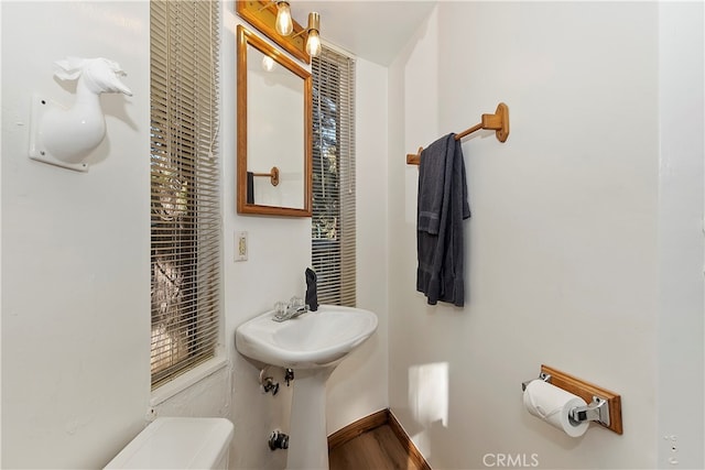 bathroom featuring hardwood / wood-style floors and toilet