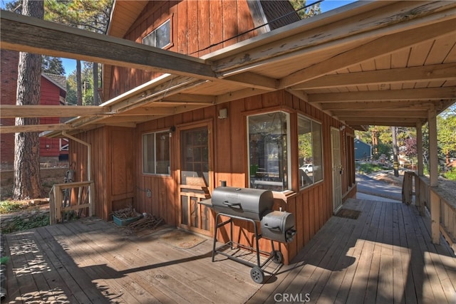 wooden terrace featuring area for grilling