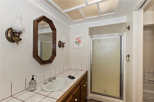 bathroom featuring walk in shower and vanity