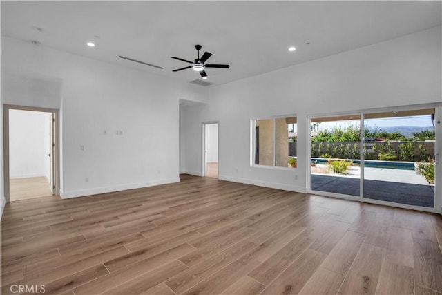 unfurnished living room featuring ceiling fan and light hardwood / wood-style flooring