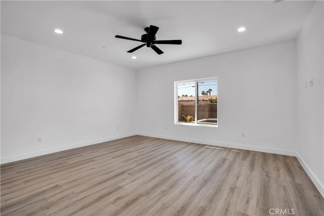 empty room featuring ceiling fan and light hardwood / wood-style floors