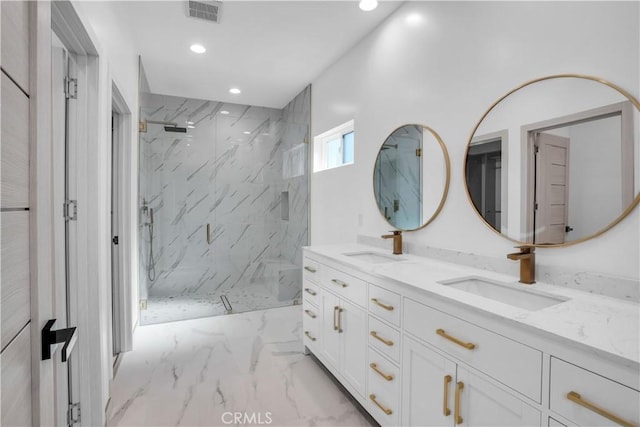 bathroom featuring a tile shower and vanity