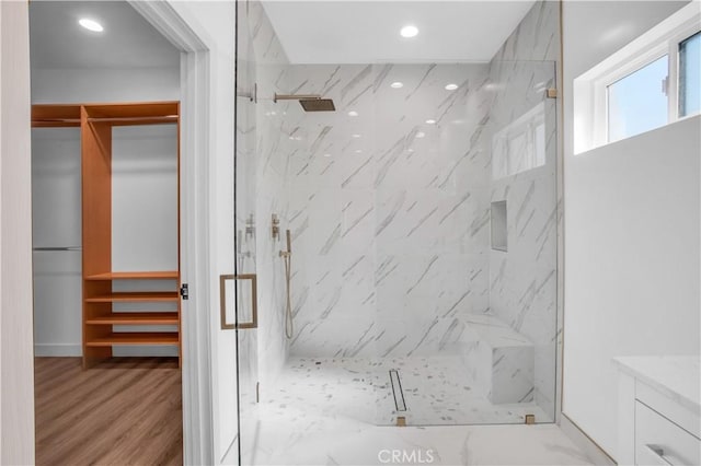 bathroom featuring hardwood / wood-style floors and a shower with door