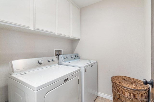 washroom with washer and clothes dryer and cabinets