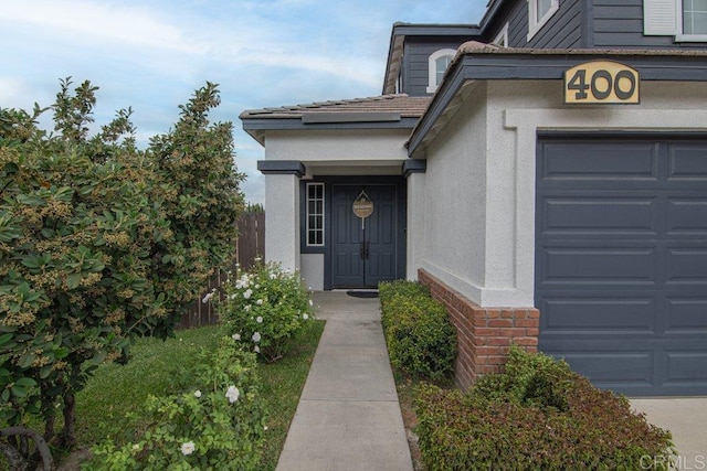 view of exterior entry with a garage