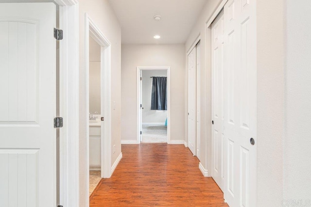 hallway with hardwood / wood-style flooring