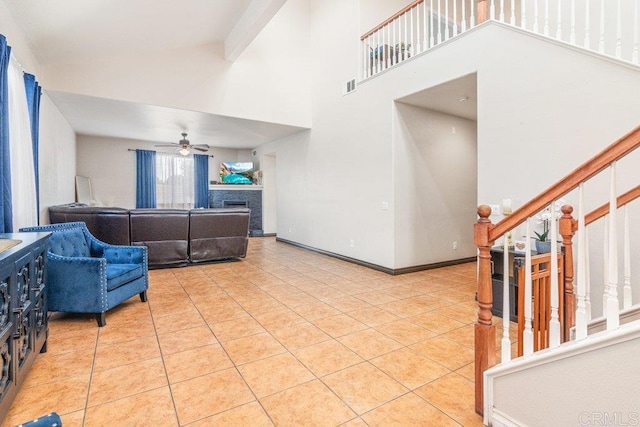 living room with light tile patterned floors, high vaulted ceiling, and ceiling fan