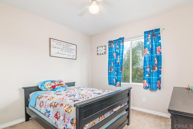 carpeted bedroom featuring multiple windows and ceiling fan