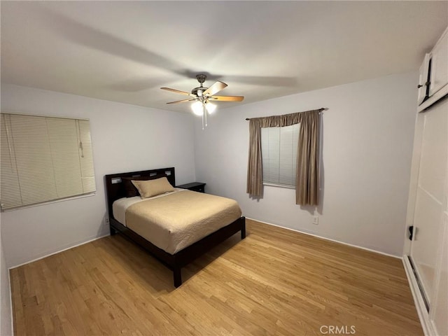 bedroom featuring light hardwood / wood-style floors and ceiling fan