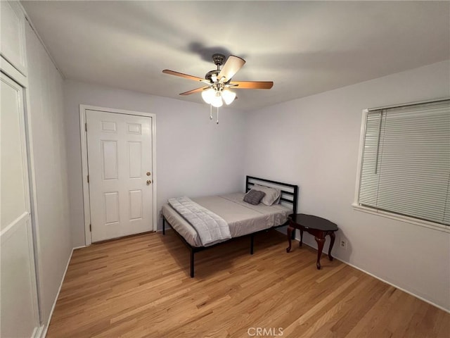 bedroom with light hardwood / wood-style floors and ceiling fan