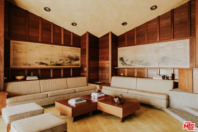 living room with light colored carpet and high vaulted ceiling