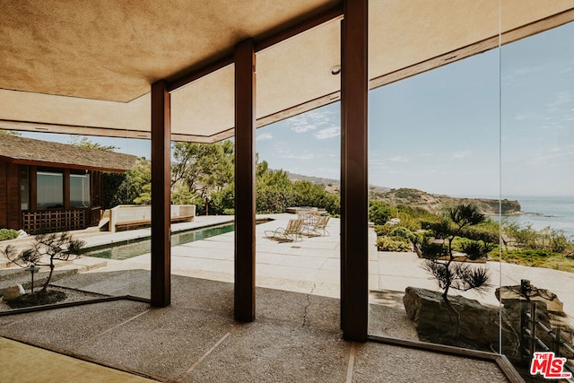 view of patio with a water view