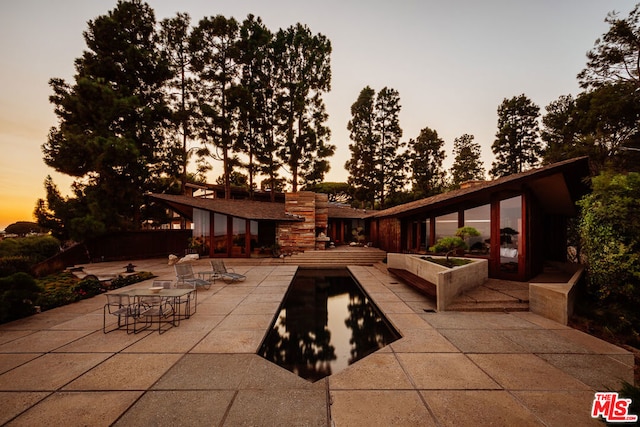 view of patio terrace at dusk