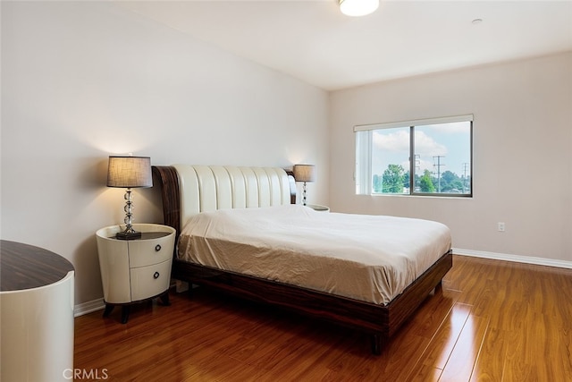 bedroom with hardwood / wood-style flooring