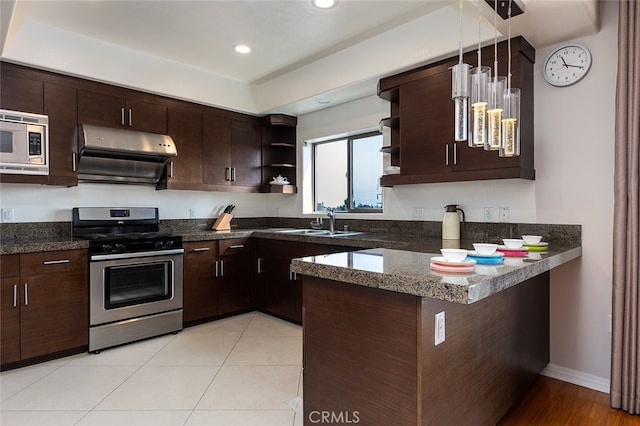 kitchen featuring appliances with stainless steel finishes, dark brown cabinetry, and kitchen peninsula