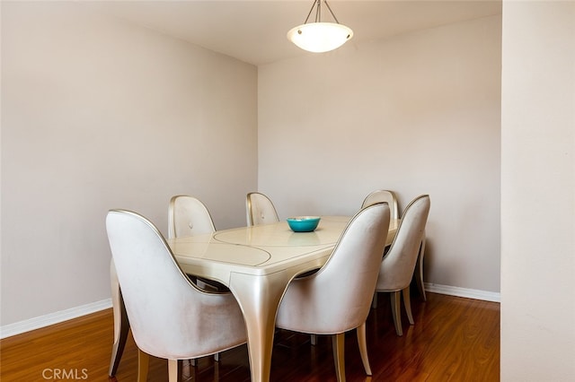 dining area with dark hardwood / wood-style flooring