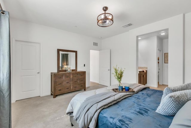 carpeted bedroom with connected bathroom