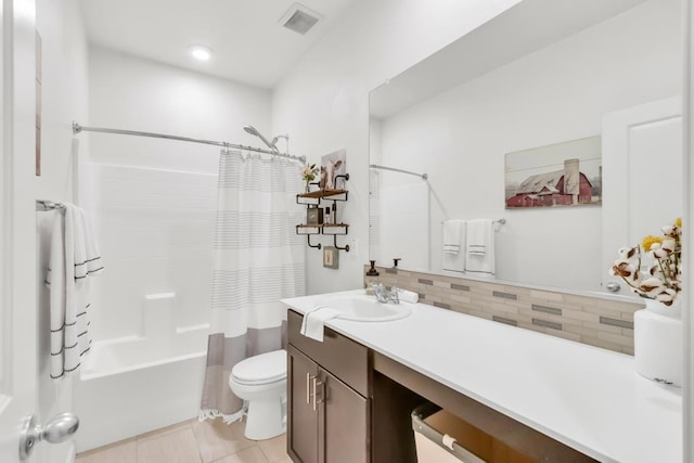 full bathroom featuring toilet, decorative backsplash, shower / bath combo with shower curtain, tile patterned flooring, and vanity