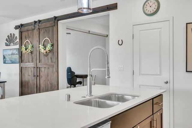 kitchen with a barn door and sink