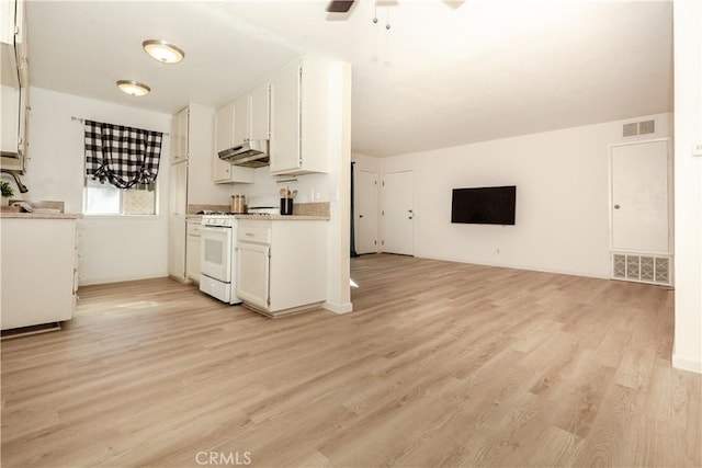 kitchen with ceiling fan, sink, white range with gas stovetop, light hardwood / wood-style floors, and white cabinets