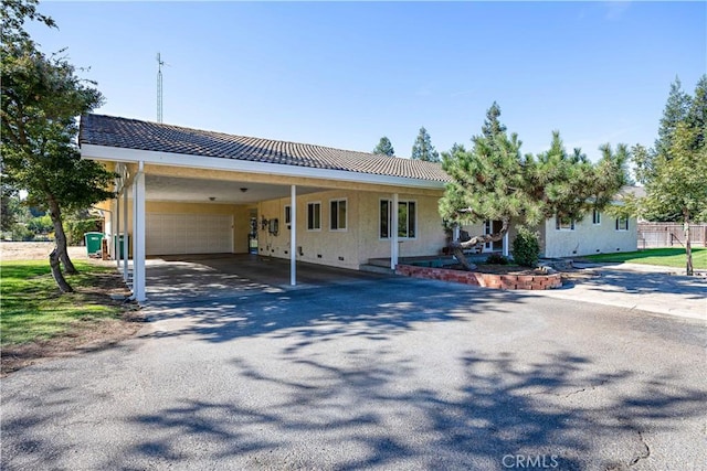 view of front facade with a garage and a carport