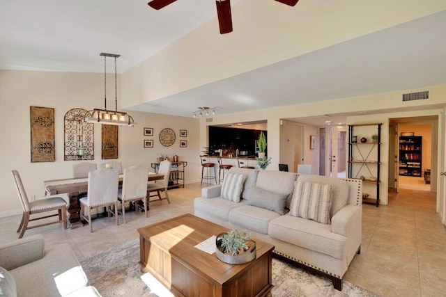 tiled living room with ceiling fan