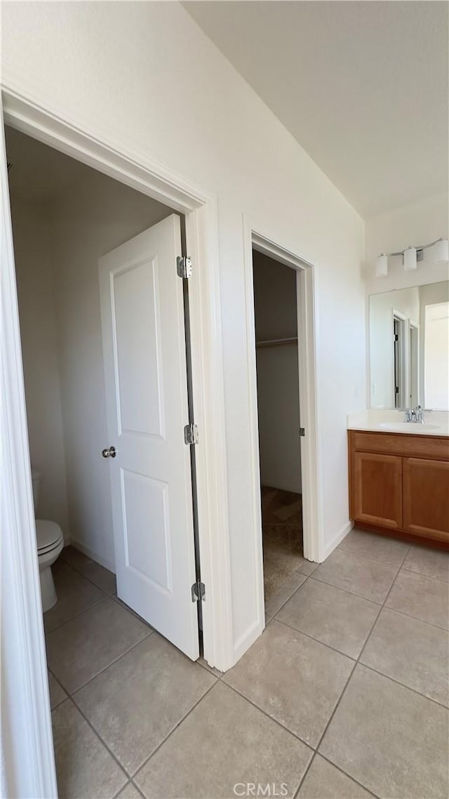 bathroom featuring tile patterned floors, toilet, and vanity