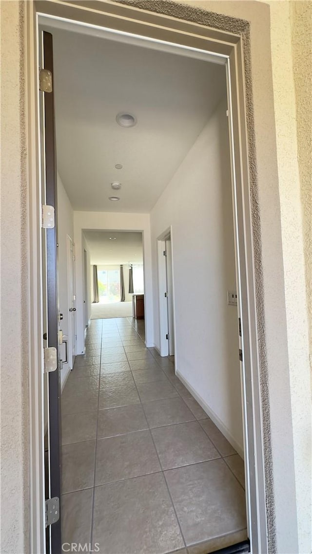 hall featuring tile patterned flooring