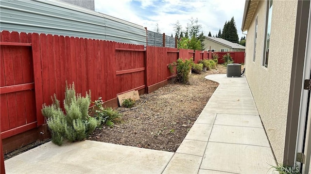 view of yard featuring cooling unit and a patio area