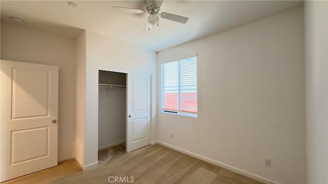 unfurnished bedroom featuring light colored carpet, ceiling fan, and a closet