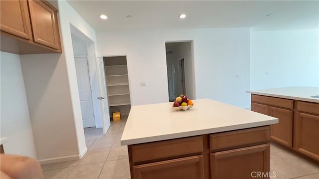 kitchen featuring light tile patterned flooring and a center island